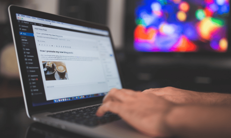 writing blog on a laptop
