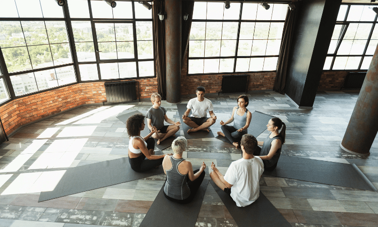 A hot yoga studio is a great setting for a class like the one pictured here, but teacher should be aware of the signs of heat exhaustion.