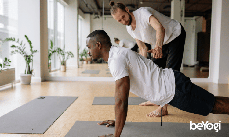 yoga teacher mistakes A yoga teacher avoids yoga mistakes and teaches a yogi in his class.