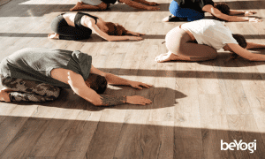 A yoga class walks through their relaxing yoga poses.
