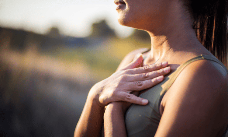 A yogi practices her self love through breathing through the niyamas.