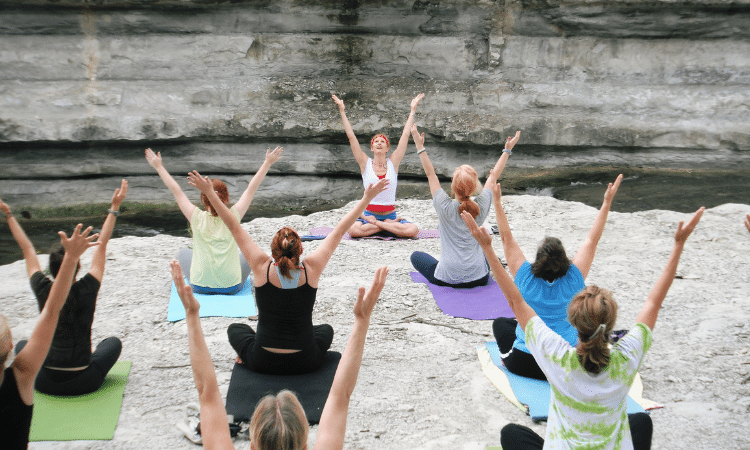 A yoga teacher leads a yoga class on International Day of Yoga.
