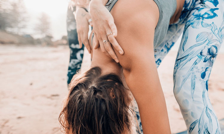 A yogi goes through an in-person yoga teacher training course so she can provide in-person classes for her students.
