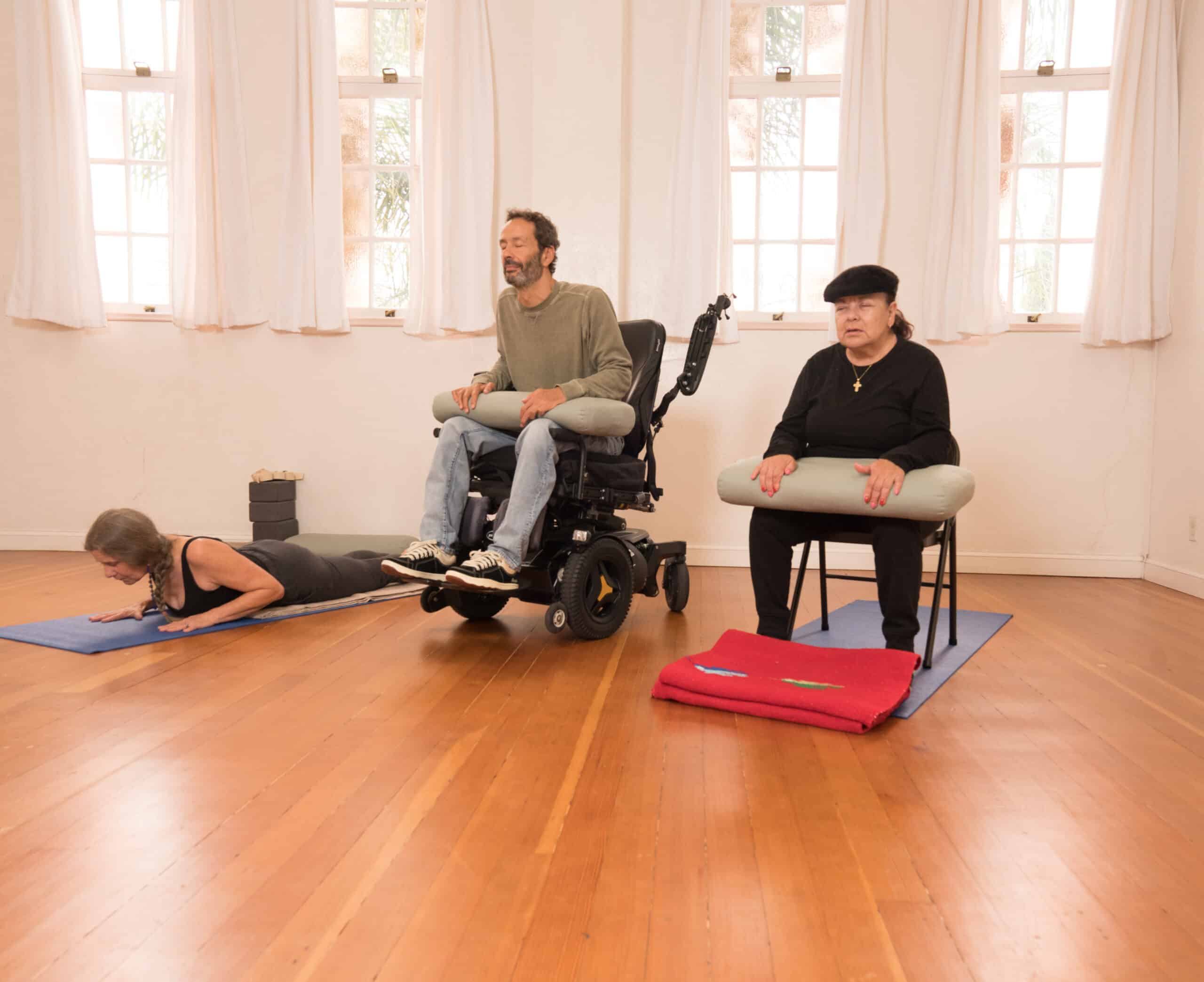 Yogis experience accessible yoga during their yoga class.