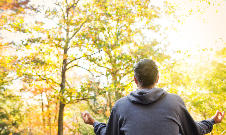 A male yogi practices his outdoor yoga during the crisp Fall weather.