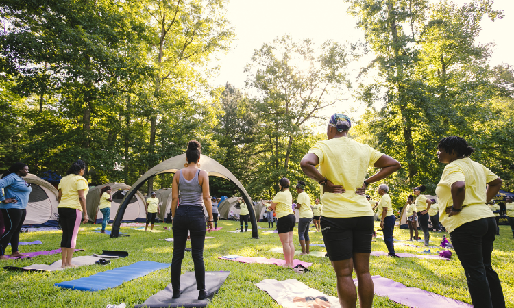 A group of yogis embark on their yoga teacher training (YTT) session in an outdoor setting.
