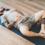 A man does a round of yoga therapy to help with his PTSD.