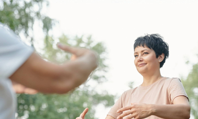 qigong-yoga A yoga instructor teaches their student about qigong yoga.