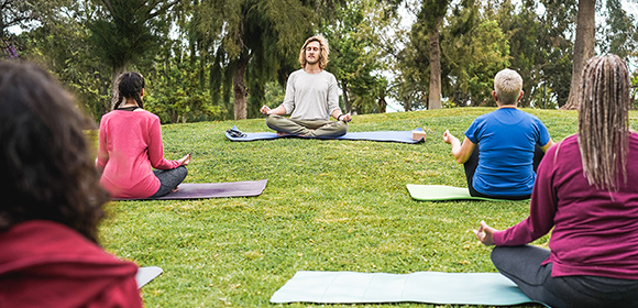 Part-time yoga instructor teaching yoga outside.