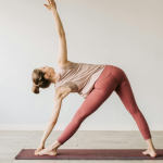 A yogi practices slow flow yoga in her class.