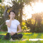 A yogi practices her ujjayi breathing on her mat.