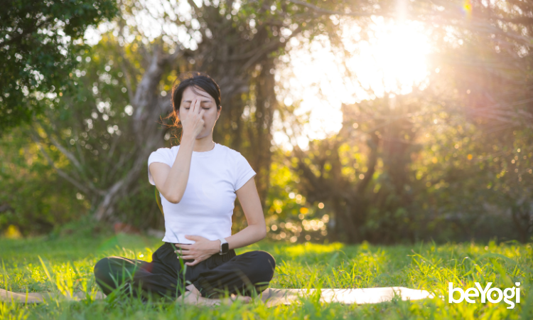 A yogi practices her ujjayi breathing on her mat.