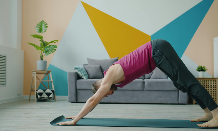 downward-dog-pose A yogi shows off a downward dog, one of the best yoga poses for back pain.