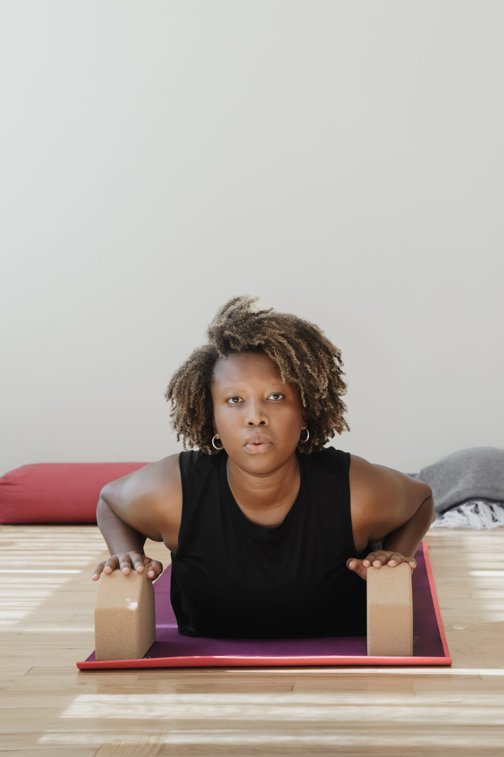 A yogi practices wrist safety with her blocks. 