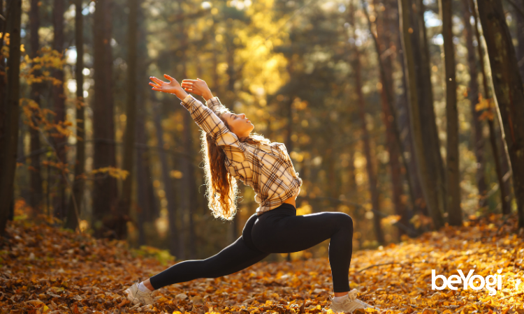 A yoga instructor plays with october yoga class themes in a fall setting.