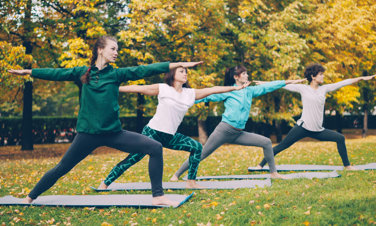 A group of yoga students goes through a fall yoga class themes workshop.